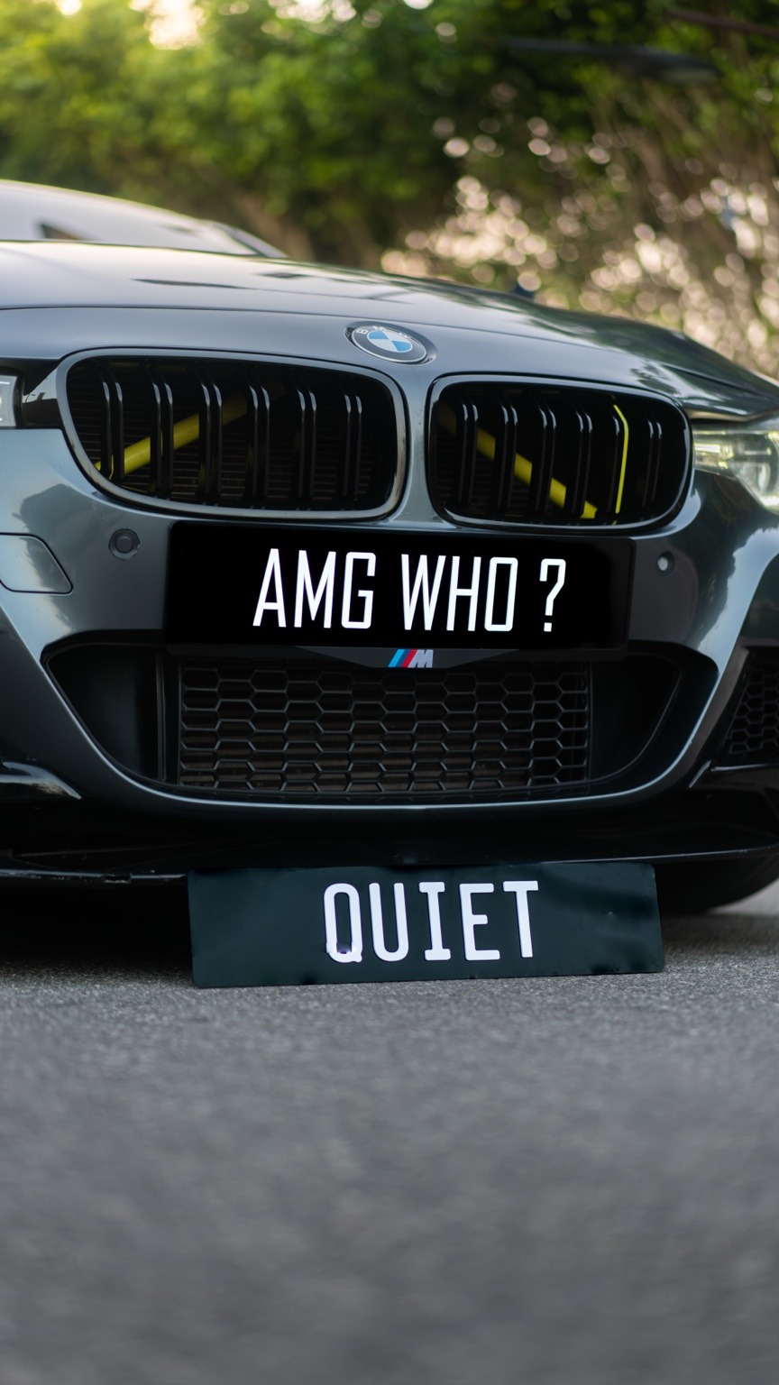 BMW displaying AMG WHO and QUIET plates