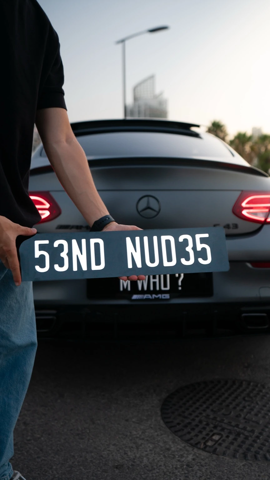 Statement plate held in front of a Mercedes-Benz